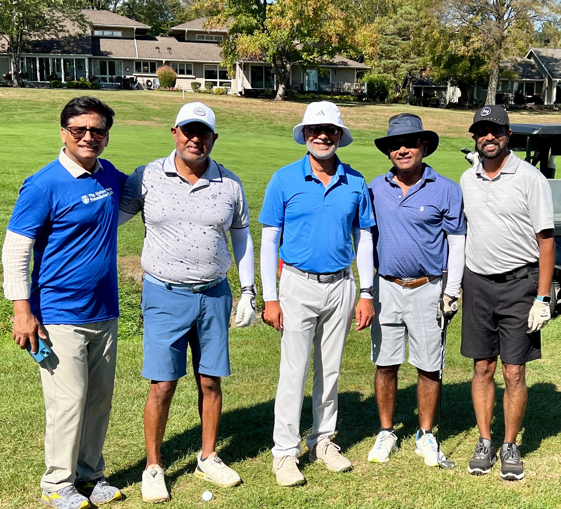 Five golfers standing together on the golf course at The Grizzly Golf & Social Lodge