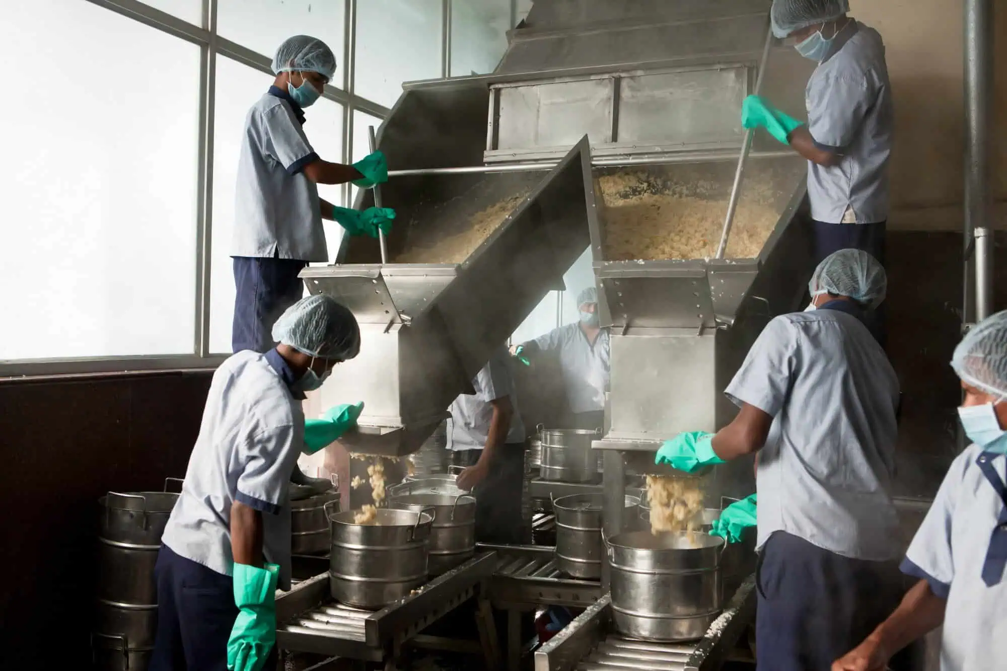 Workers filling meal containers
